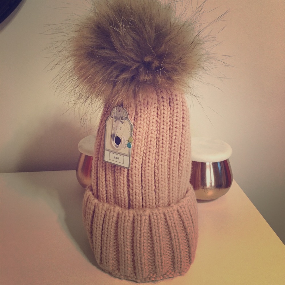 Woman's pink winter hat with removable pom pom